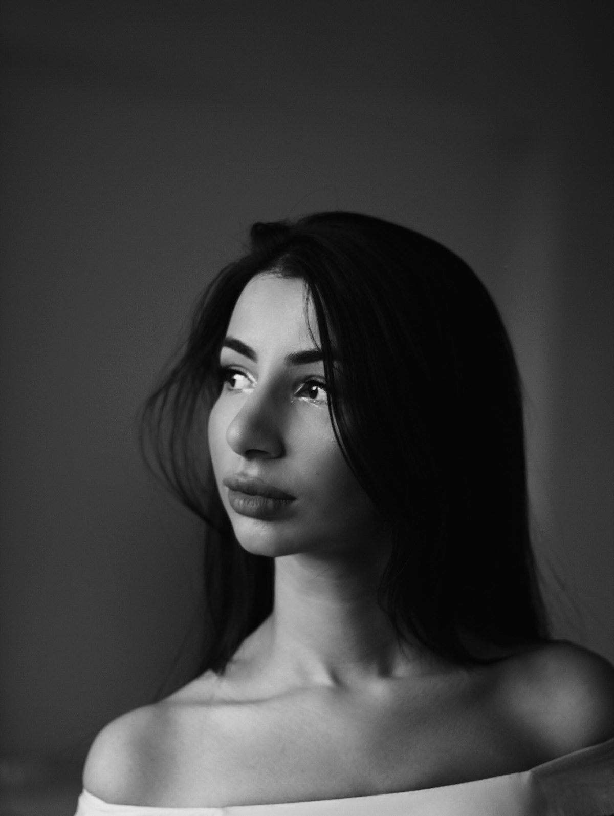Low-angle cinematic power pose portrait with dynamic background and commanding presence